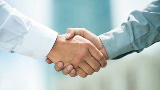 Photo of two business people shaking hands.