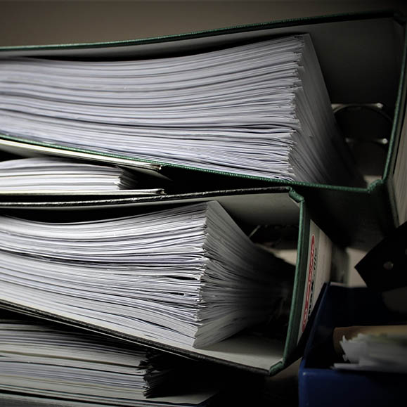 Close-up photo of binders full of papers