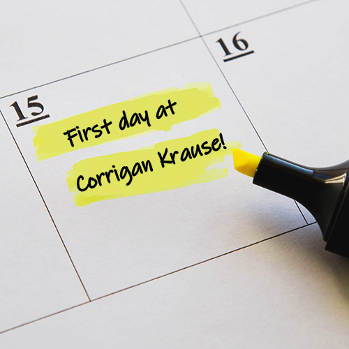 Calendar planner with "First day at Corrigan Krause!" highlighted